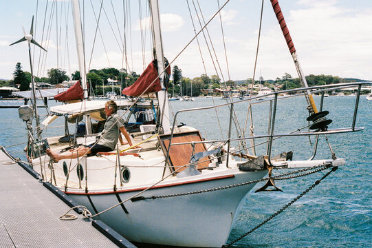 Vintage sailing boat docked at scenic harbor