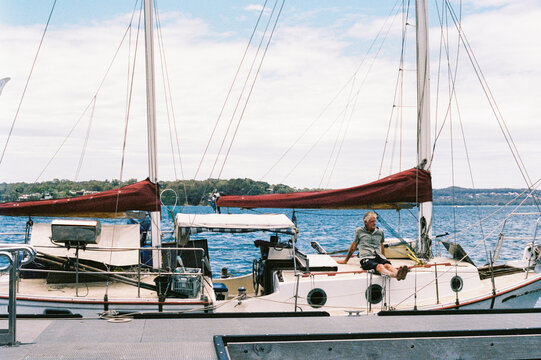 Person in a  yacht peacefully anchored in calm waters.