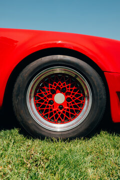 Closeup of red sports car wheel and tire
