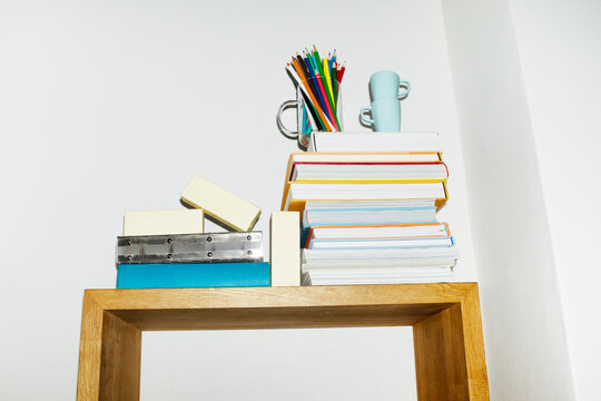 Daily life items books, coffee cups, shoes, folders in a shelf