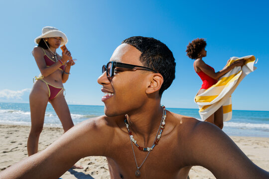 Friends enjoying sunny summer beach day
