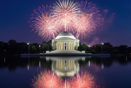 Spectacular Fourth of July fireworks illuminate the Jefferson Memorial reflected in the Tidal Basin at night.