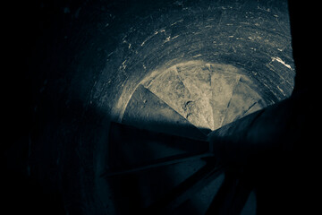 Fototapeta premium Deep Well Shaft with Shadowed Circular Opening and Textured Walls