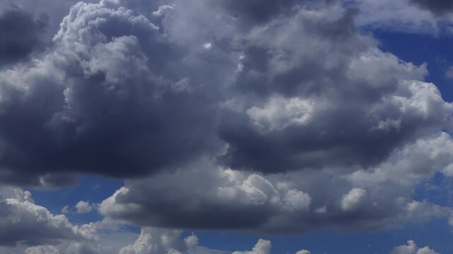 Timelapse of white clouds moving rapidly across a clear blue sky.