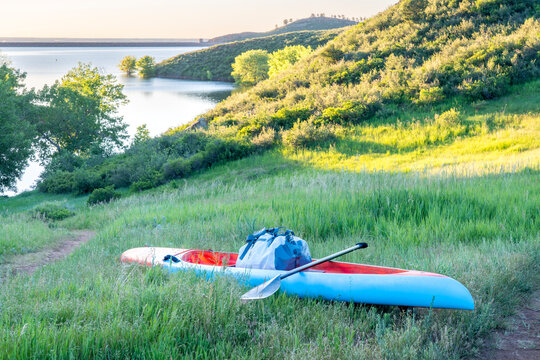 Long and narrow racing stand up paddleboard on a shore of  mountain lake in early summer - Horsetooth Reservoir in Fort Collins, Colorado, fitness and recreation concept