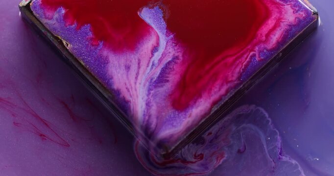 Ink drip. Glass cube angle. Defocused red purple maroon color geometric texture bright droplets flowing on abstract art background.