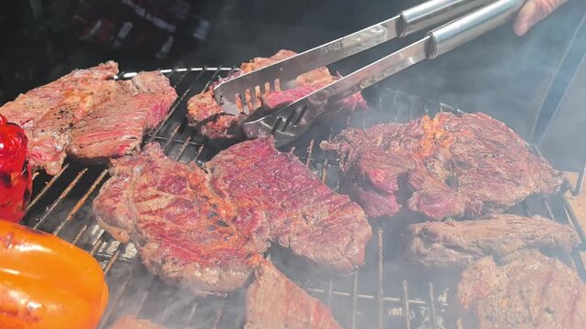 Grilled Meat Cooking on BBQ Grill with Flames and Smoke