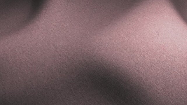 Close up of soft pink fabric texture background, elegant wavy textile pattern with smooth folds and shadows, luxurious material for design and decoration