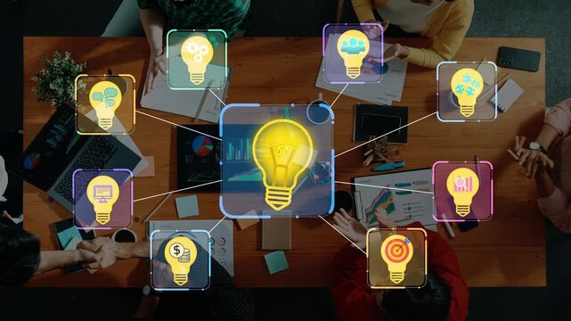 Creative brainstorming session with team members using light bulb icons to symbolize innovative ideas and digital collaboration around a wooden table setting. Entropy.