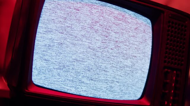 Retro TV, vintage television In a nostalgic setup, a retro TV displays grain on screen, scary halloween night device good for chroma key and green screen.