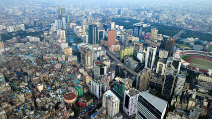Fototapeta premium This impressive aerial view of Dhaka highlights the modern infrastructure and dynamic urban landscape of Bangladesh’s capital. The image showcases a network of elevated flyovers, highways, rail lines.