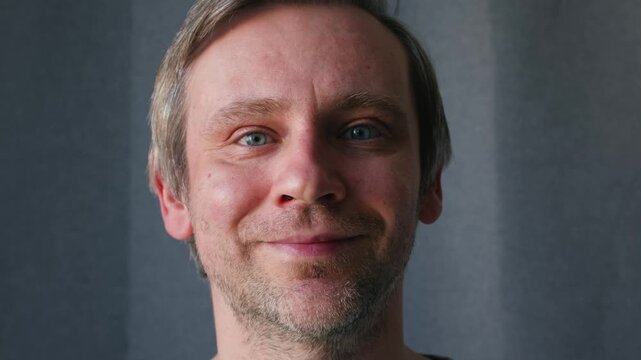 Smiling middle aged man 40 years old standing in office, portrait. Smiling blue eyes office worker, freelancer.