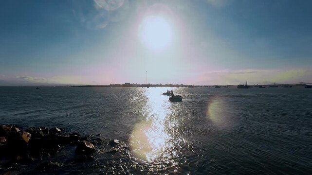 Traditional Vietnamese Basket Boat under Bright Sun Glare on Sea