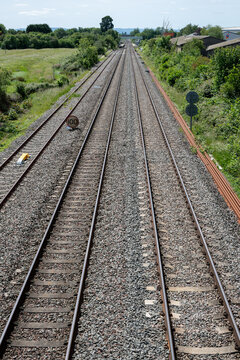 Double-track railway main line curving through green countryside near Ashchurch, Tewkesbury, Gloucestershire