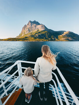Mother and child travel by ferry in Norway enjoying sea and island view, mom and daughter on summer vacation tour in Arctic outdoor parent and kid together on cruise trip sightseeing natural landmarks