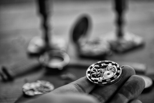 Watchmaker adjusting mechanical watch, repair shop