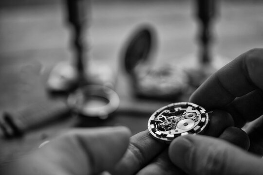 Watchmaker adjusting mechanical watch, repair shop