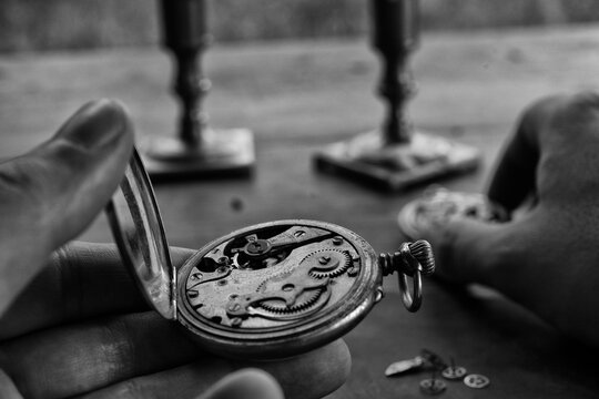 Watchmaker adjusting mechanical watch, repair shop