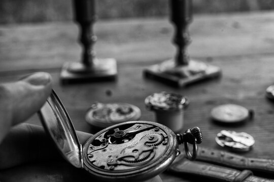 Watchmaker adjusting mechanical watch, repair shop