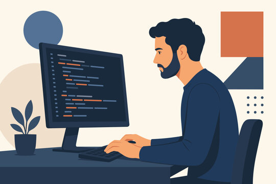 A young male programmer writing code on his computer monitor while sitting at a desk in a modern office environment