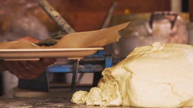 Cook shaping handmade tortilla dough before pressing and cooking