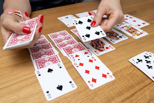Woman's hands holding a fan of playing cards &mdash; card game, leisure, entertainment