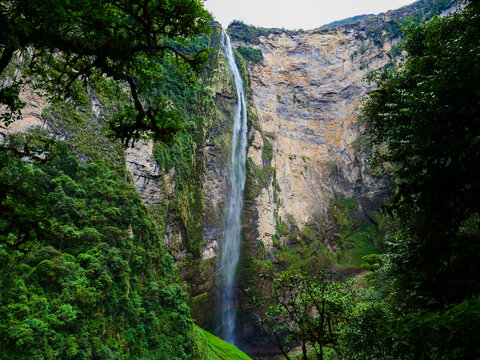 Breathtaking view of Gocta Waterfall cascading down a high cliff in the lush green rainforest of Peru