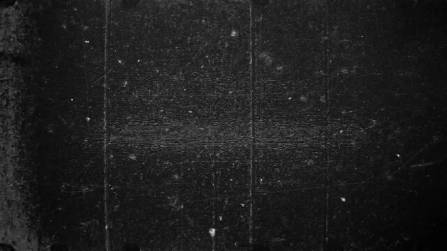 Vintage old film look overlay with white scratches heavy dust noise and grain texture on black background 4k video