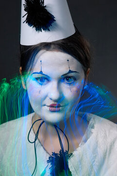 Clown woman close up portrait with creative blue neon light trails effect