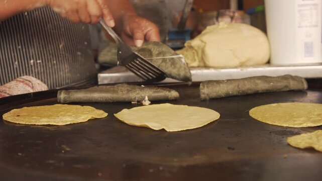 Street food vendor preparing tacos and quesadillas