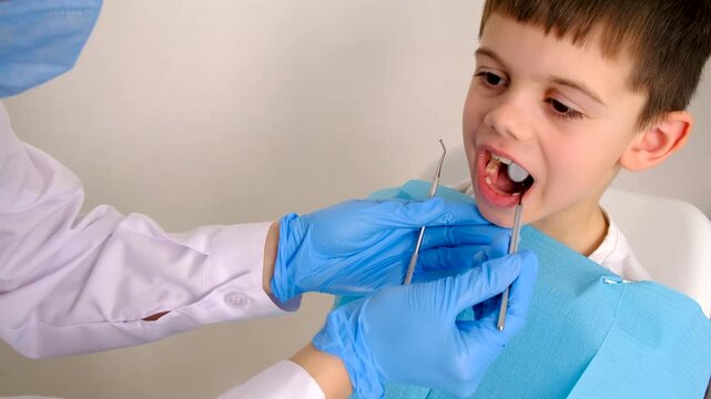 A child at the dentist gets his teeth treated. Selective focus.