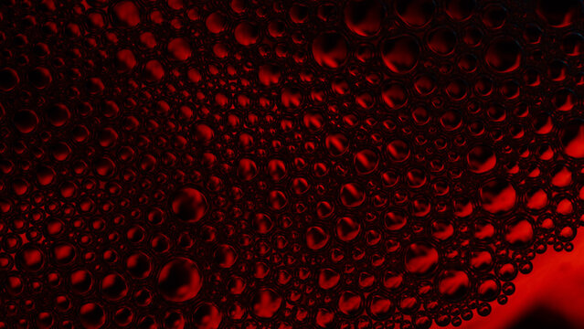 Red bubbles creating an abstract liquid pattern texture