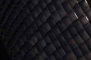 Fototapeta premium Macro of a dark photography studio softbox honeycomb grid abstract pattern.