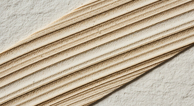 Beige sandstone surface with parallel ridged texture and grain