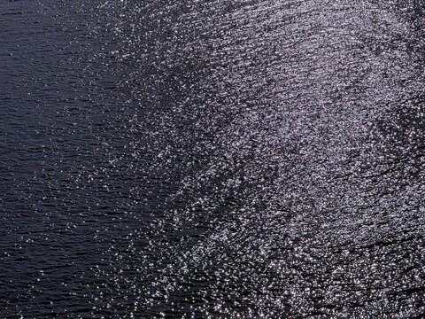 Glittering sea water surface at night.