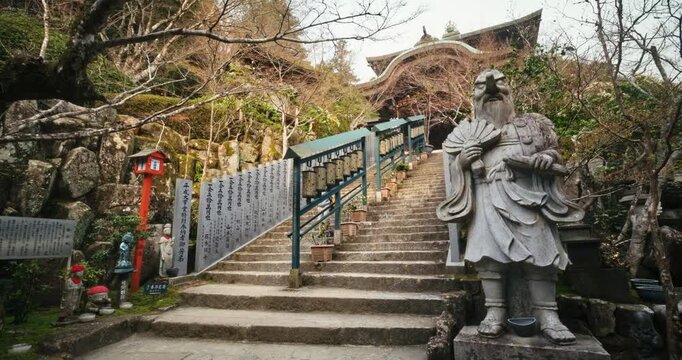 Stone Guardian Statue at Japanese Temple Staircase In Hiroshima As Boy Walks Down - Steady Cam Shot