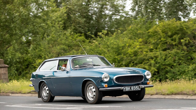 Stony Stratford,Bucks,UK - June 7th 2026:1973 Volvo P1800 classic  car driving on a British road