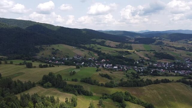 Aerial view of EuroVelo 11 bike path along Poprad river in summer, drone shot of scenic cycling route between Krynica-Zdroj, Muszyna and Rytro in Beskid Sadecki mountains, Poland.