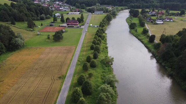Aerial view of EuroVelo 11 bike path along Poprad river in summer, drone shot of scenic cycling route between Krynica-Zdroj, Muszyna and Rytro in Beskid Sadecki mountains, Poland.