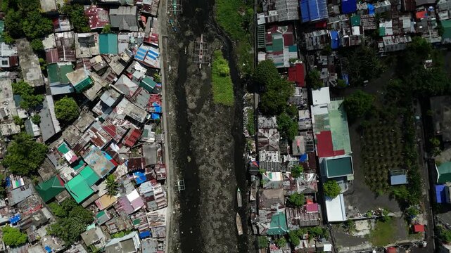 Aerial view of city canal surrounded by dense housing, Tabaco City, Albay Philippines