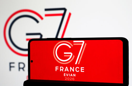 G7 France &Eacute;vian 2026 logo on smartphone and screen. Illustrative photos of international politics.