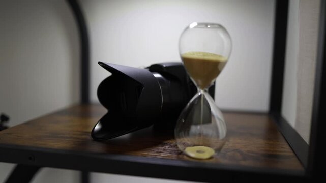Hourglass with flowing sand beside a camera lens symbolizing limited time photography deadlines creative workflow productivity and the value of every moment
