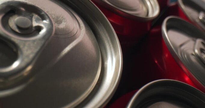 Close-up slow motion of red soda cans in dynamic arrangement