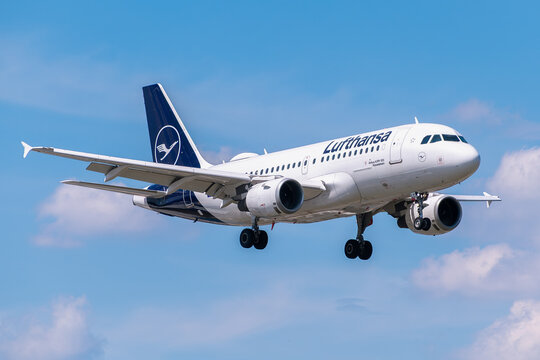 Lufthansa airliner descending for landing under blue sky