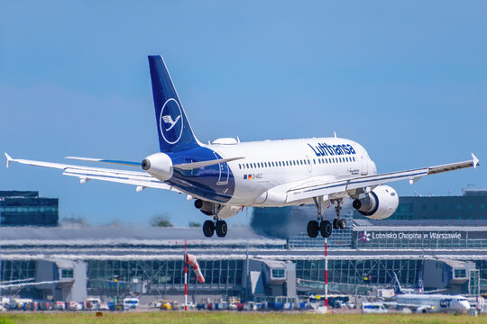 Lufthansa Airbus A319-100 passenger jet, registration D-AILC, landing with airport terminal in background