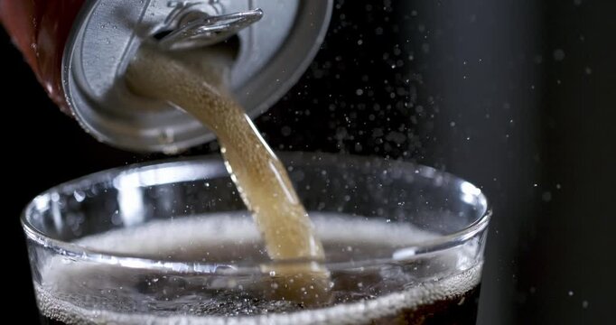 Pouring soda in slow motion showing details of bubbles and liquid