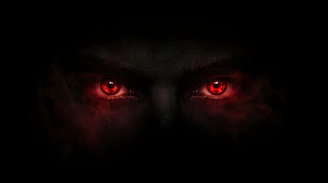 evil sinister glowing red eyes emerging from complete darkness