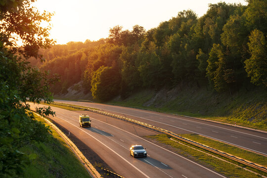 White Car Driving Down Empty Multilane Highway at Golden Hour Sunset, The Concept of Freedom
