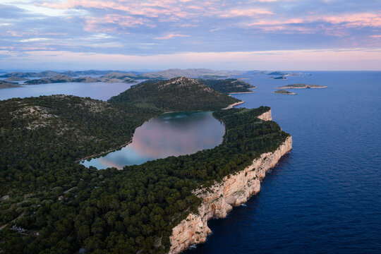 Aerial view of Lake Mir and the dramatic seaside cliffs in Telascica Nature Park, Dugi Otok, Croatia