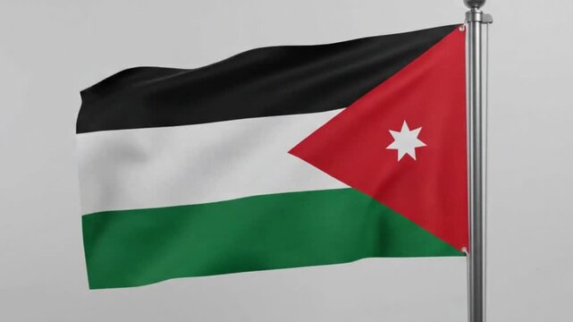 Waving flag of jordan on a flagpole against a plain background